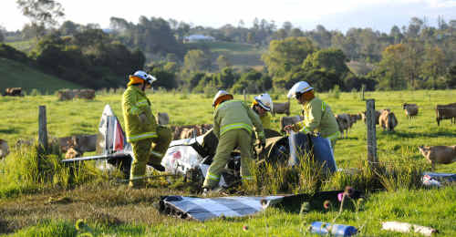 Gympie Fire and Rescue personnel cover the body of a dead pilot who crashed his replica Spitfire into a paddock off Lagoon Pocket Road yesterday. Gympie Fire and Rescue personnel cover the body of a dead pilot who crashed his replica Spitfire into a paddock off Lagoon Pocket Road yesterday.
